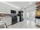 Well-equipped kitchen with a range, microwave, and black refrigerator, complemented by white cabinets at 6623 Northhaven Ct, Riverview, FL 33578