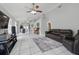 Spacious living room featuring tile flooring, a ceiling fan, and ample natural light, ideal for relaxation at 6623 Northhaven Ct, Riverview, FL 33578