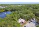 Enjoy this community aerial view with lush landscaping, lake, and a peaceful surrounding environment at 706 1St Ct, Palm Harbor, FL 34684