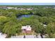 Experience this community aerial view with a beautiful lake, lush landscaping, and a peaceful surrounding area at 706 1St Ct, Palm Harbor, FL 34684