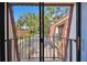 A balcony with black metal railings overlooks treetops under a blue sky at 706 1St Ct, Palm Harbor, FL 34684