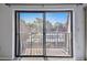 A view from the carpeted bedroom looks out to the balcony at 706 1St Ct, Palm Harbor, FL 34684
