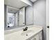 The white bathroom vanity with a brushed black faucet has a light gray wall color at 706 1St Ct, Palm Harbor, FL 34684