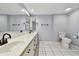 Large bathroom featuring double sinks, a vanity with storage, and a toilet at 706 1St Ct, Palm Harbor, FL 34684