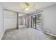 Bedroom featuring mirrored closet doors and sliding glass doors that leads to an outdoor balcony at 706 1St Ct, Palm Harbor, FL 34684