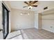 Bright bedroom with tile flooring, ceiling fan and sliding glass door to the outside at 706 1St Ct, Palm Harbor, FL 34684