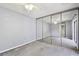 A bedroom with mirrored closet doors is spacious, and has plush neutral carpeting at 706 1St Ct, Palm Harbor, FL 34684