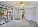 Bedroom featuring a balcony overlooking the neighborhood, neutral carpeting, and a mirrored closet at 706 1St Ct, Palm Harbor, FL 34684