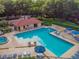 Aerial shot of a clean community pool with a clubhouse and lounge chairs around it at 706 1St Ct, Palm Harbor, FL 34684