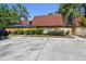 Charming condo with a terracotta-tiled roof, screened in porch, and well-maintained landscaping at 706 1St Ct, Palm Harbor, FL 34684