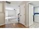 Hallway view showing access to the living room, a laundry room, and staircase at 706 1St Ct, Palm Harbor, FL 34684