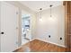 Hallway view showing access to a bathroom and a kitchen eating area at 706 1St Ct, Palm Harbor, FL 34684