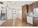 Eat-in kitchen boasts wooden cabinets, stainless dishwasher, and convenient access to the stairs at 706 1St Ct, Palm Harbor, FL 34684