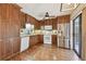 Updated kitchen with stainless steel appliances, wood cabinets, and decorative backsplash at 706 1St Ct, Palm Harbor, FL 34684