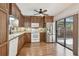 Updated kitchen featuring wood cabinets, stainless steel appliances, and sliding glass door to a patio at 706 1St Ct, Palm Harbor, FL 34684