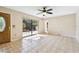 Inviting living room with tiled floor, ceiling fan, and sliding door to patio area at 706 1St Ct, Palm Harbor, FL 34684