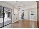 Living room adjacent to an enclosed patio, staircase, and doorway to a laundry room at 706 1St Ct, Palm Harbor, FL 34684