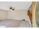 Bright living room featuring tiled floors, ceiling fan, staircase and a front door at 706 1St Ct, Palm Harbor, FL 34684