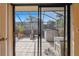 Enclosed patio area with screened enclosure, equipped with furniture and potted plants at 706 1St Ct, Palm Harbor, FL 34684