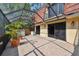 The patio has potted plants, light colored tile, and a screen surround at 706 1St Ct, Palm Harbor, FL 34684