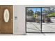 A view from indoors looks out at a screened in patio at 706 1St Ct, Palm Harbor, FL 34684