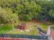 Aerial view featuring a cozy community playground amongst a landscape of lush trees at 706 1St Ct, Palm Harbor, FL 34684