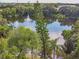 Scenic pond with a fountain, framed by lush greenery and towering palm trees at 706 1St Ct, Palm Harbor, FL 34684