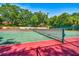 View of two red and green tennis courts with new nets at 706 1St Ct, Palm Harbor, FL 34684