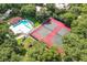 Aerial view of tennis courts and a community pool surrounded by mature landscaping at 706 1St Ct, Palm Harbor, FL 34684
