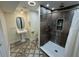 This bathroom features a tiled shower and a stylish pedestal sink at 7102 Reindeer Rd, Tampa, FL 33619