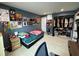 This bedroom features tile flooring, light blue walls, a closet, and quirky decor at 7102 Reindeer Rd, Tampa, FL 33619