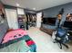 This spacious bedroom includes closet, shelving, a television, and tile flooring at 7102 Reindeer Rd, Tampa, FL 33619