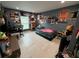 An expansive view of a bedroom showcasing posters, shelving, closet, and tile flooring at 7102 Reindeer Rd, Tampa, FL 33619