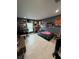 This bedroom features tile flooring, a window, and dark blue walls decorated with album covers and collectibles at 7102 Reindeer Rd, Tampa, FL 33619