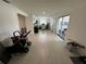 This living room features tile flooring, white walls, a sliding glass door, and a ceiling light at 7102 Reindeer Rd, Tampa, FL 33619
