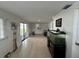 This living room features tile flooring, white walls, a sliding glass door, and an aquarium at 7102 Reindeer Rd, Tampa, FL 33619