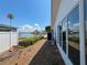 Exterior view featuring the side of the house, landscaping, and waterfront in the background at 719 59Th Ave, St Pete Beach, FL 33706