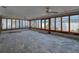 Bright sunroom with walls of windows, offering ample sunlight and stunning views, awaiting its next chapter at 719 59Th Ave, St Pete Beach, FL 33706