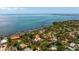 Panoramic aerial view showcasing the coastal property with ocean views and lush greenery at 7235 Sunshine S Dr, St Petersburg, FL 33705