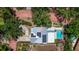 Overhead aerial view showcasing the property's layout, solar panels, swimming pool, and well-manicured landscaping at 7235 Sunshine S Dr, St Petersburg, FL 33705