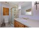 Cozy bathroom featuring a glass door shower, toilet, and wood trim vanity at 7235 Sunshine S Dr, St Petersburg, FL 33705