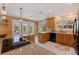 Bright kitchen with wood cabinets, granite countertops, and view of the outdoors at 7235 Sunshine S Dr, St Petersburg, FL 33705