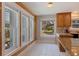 Bright and sunny kitchen featuring a window-filled breakfast nook with a view of the front yard at 7235 Sunshine S Dr, St Petersburg, FL 33705