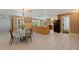 Open kitchen featuring a large island, wood cabinets, and an adjacent dining area at 7235 Sunshine S Dr, St Petersburg, FL 33705