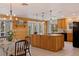 Bright kitchen showcasing an island, wood cabinets, and natural light from large windows at 7235 Sunshine S Dr, St Petersburg, FL 33705