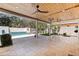 Spacious covered patio with ceiling fans overlooking a pool and landscaped backyard at 7235 Sunshine S Dr, St Petersburg, FL 33705