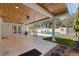 Inviting covered patio offering a view of the pool and lush, well-maintained backyard at 7235 Sunshine S Dr, St Petersburg, FL 33705