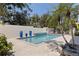 Backyard pool area with travertine pavers, contemporary water feature and privacy wall at 7235 Sunshine S Dr, St Petersburg, FL 33705