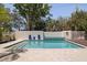 Backyard swimming pool surrounded by tile and a privacy wall, with a wooden deck at 7235 Sunshine S Dr, St Petersburg, FL 33705
