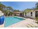 Backyard view of a private pool with a patio and tropical landscaping creating a relaxing outdoor oasis at 7235 Sunshine S Dr, St Petersburg, FL 33705
